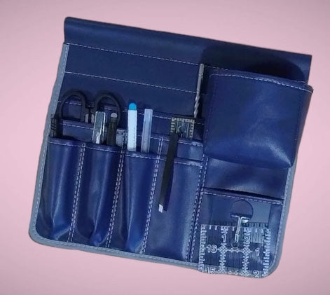 Blue Molly Caddy with various tools on a pink background