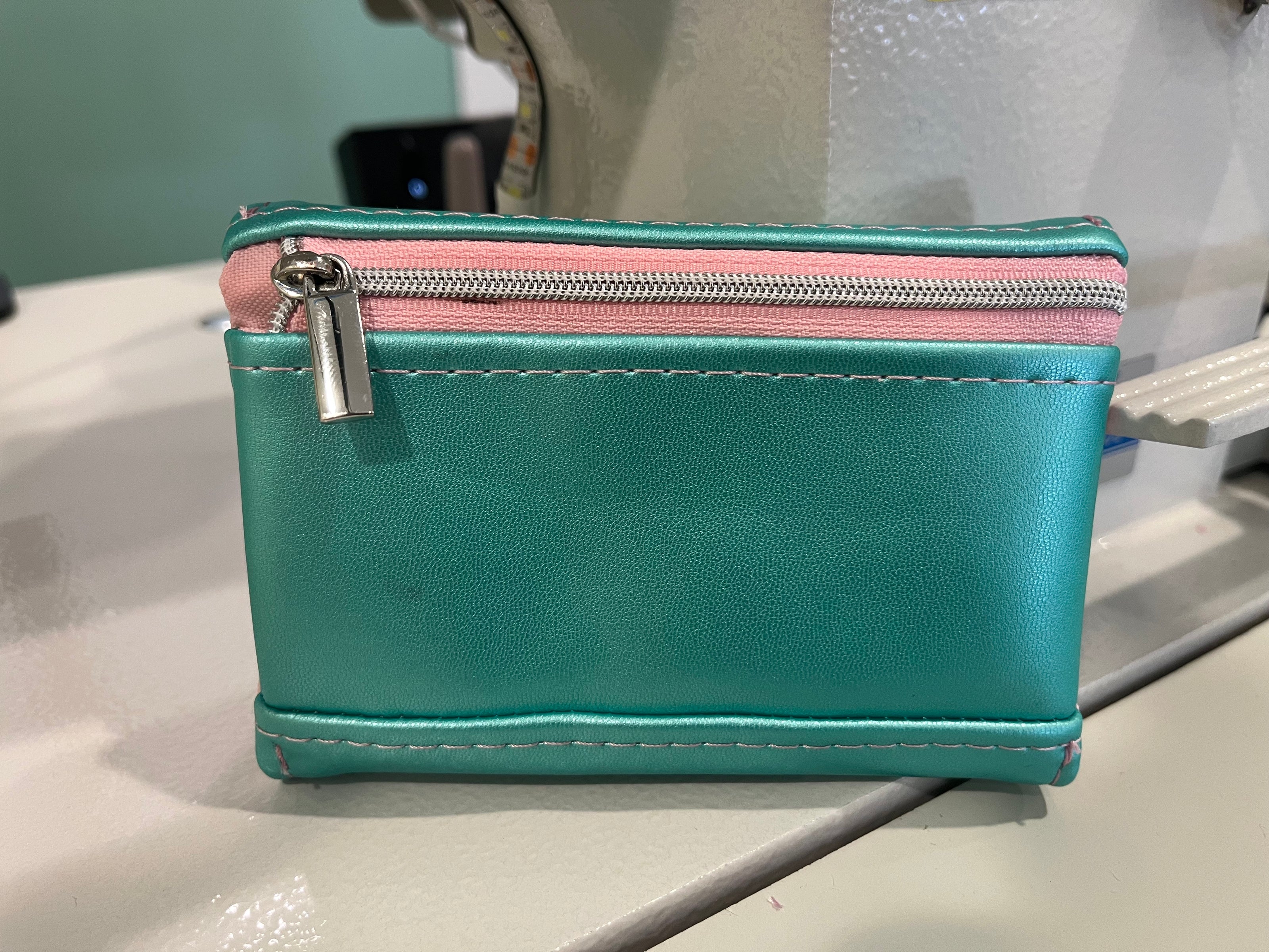 Measure and Cutt Teal pouch with pink zipper 