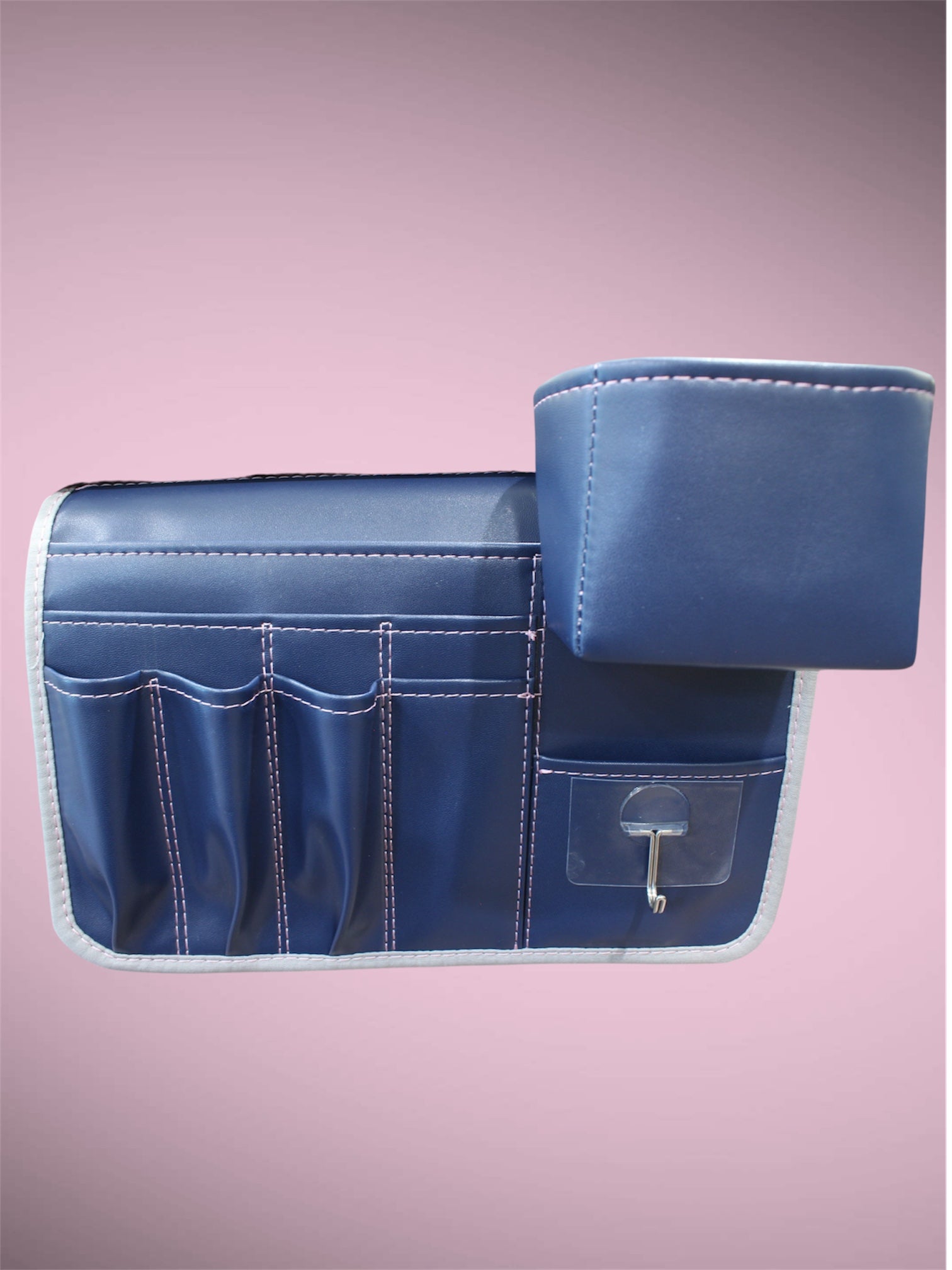 Molly Caddy Blue vinyl tool organizer with multiple pockets on a pink background